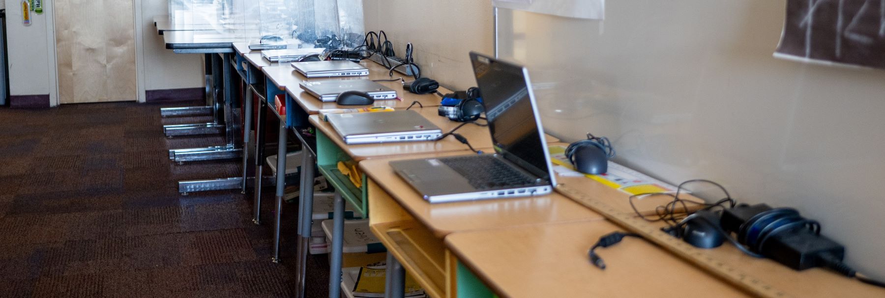 laptops on row of tables