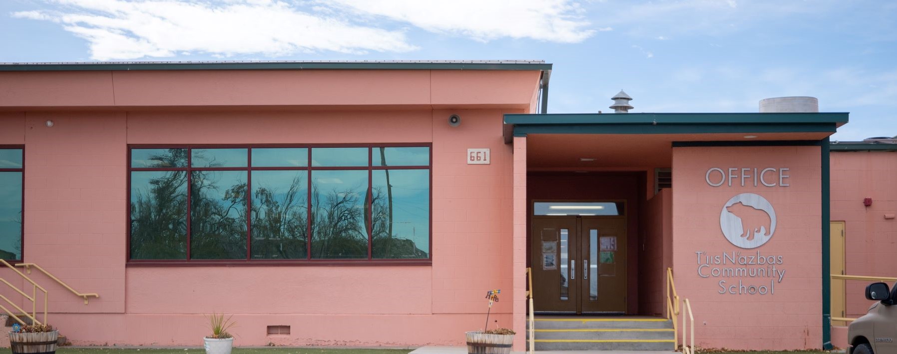 school entrance with sign for school office